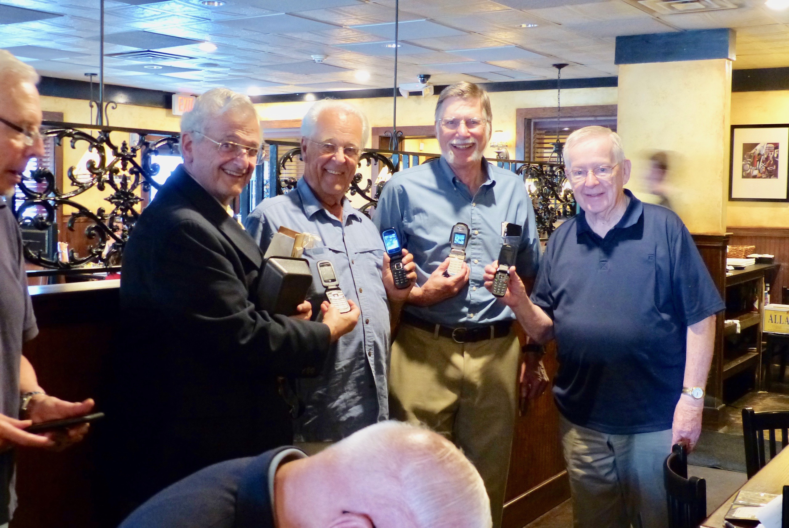 Kenn Venit, William Hennesey, Tony Riggs, John Green showing off their modern flip phones